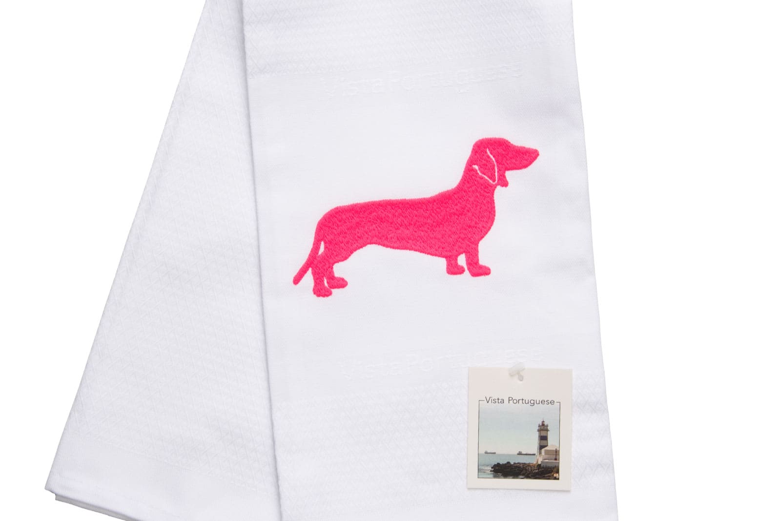 Ausschnitt des Geschirrtuch Dackel 50x70cm Neon Pink von Vista Portuguese. Es ist ein weißes Geschirrhandtuch aus Jacquardstoff mit aufgesticktem pinkem Dackelmotiv.
